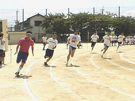 Six boys racing around a track