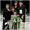 A Japanese family, wearing formal kimono, gathers for a picture
