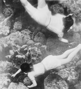 Women diving under water