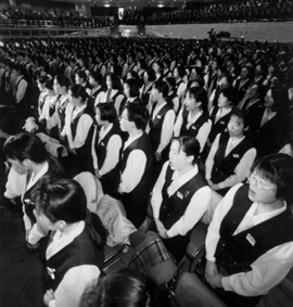 Auditorium filled with women in matching work uniforms