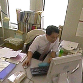 Worker sitting at his desk, using his computer