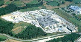 Aerial view of a large factory nestled in farm fields.