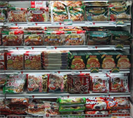 Japanese grocery store frozen foods section well-stocked with pizzas and more.